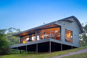 a house on a hill with a large balcony at Dee Jays Studio in Hepburn Springs