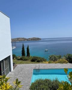 a view of the ocean from a house with a swimming pool at Villa Nafsika stunning view on the Aegean Sea in Áyioi Apóstoloi