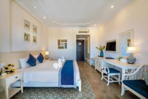 a hotel room with a bed and a desk at Lantana Riverside Hoi An Boutique Hotel & Spa in Hoi An