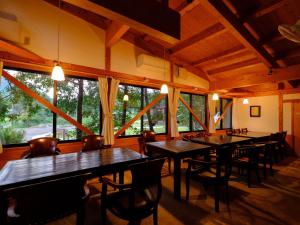 由布市The Sense of Wonder Holistic Glamping的有桌椅和窗户的餐厅