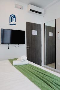 Homi Oasis at KK Times Square 和逸绿洲客房内的一张或多张床位