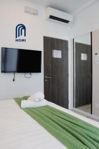 เตียงในห้องที่ Homi Oasis 和逸绿洲