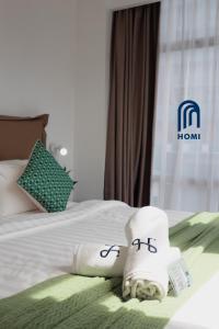 Homi Oasis at KK Times Square 和逸绿洲客房内的一张或多张床位