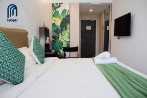 Homi Oasis at KK Times Square 和逸绿洲客房内的一张或多张床位