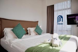 Homi Oasis at KK Times Square 和逸绿洲客房内的一张或多张床位