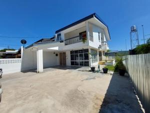 a large white house with a large driveway at Starry night homestay in Kota Kinabalu