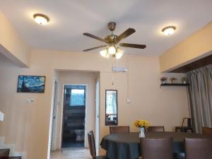 a dining room with a table and a ceiling fan at Starry night homestay in Kota Kinabalu