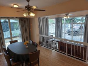 a dining room with a table and chairs in a living room at Starry night homestay in Kota Kinabalu