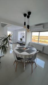 a dining room with a table and two chairs at Ca acasă Corbu in Corbu