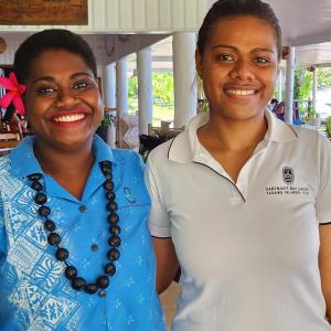 two women are standing next to each other at Oarsman's Bay Lodge in Nacula Island