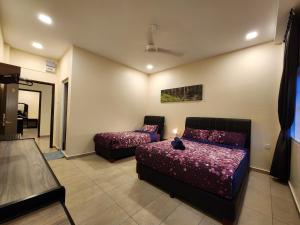 a bedroom with two beds and a couch at Fathers Guesthouse Age 7 years old and above only in Tanah Rata