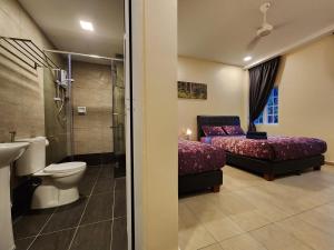 a bathroom with a toilet and a bed and a shower at Fathers Guesthouse Age 7 years old and above only in Tanah Rata +55 photos