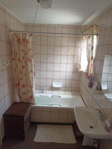 a bathroom with a tub and a sink and a toilet at Vaalaton in Oranjeville