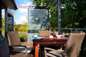 a wooden table and chairs on a patio at Eastern View Villa in Daylesford