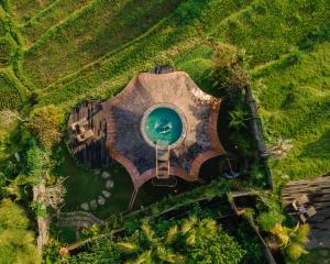 an overhead view of a house with a swimming pool at Veluvana Bali in Sidemen