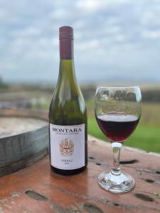 a bottle of wine next to a glass of wine at Cosy Glamping Tent 1 in Ararat