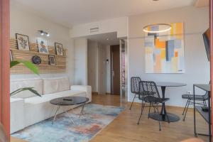 a living room with a couch and a table at Aparthotel ARDMADRID Centro in Madrid