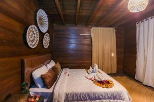 a bedroom with a bed with a bowl on it at Gili Ilalang Village in Gili Trawangan