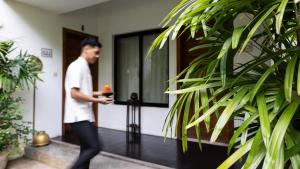 a man walking out of a house at Lynnaya Urban River Resort in Siem Reap