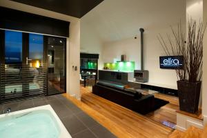 a living room with a bath tub and a tv at Elira 1 in Daylesford