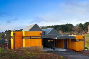 a modern house with yellow and gray at Elira 1 in Daylesford