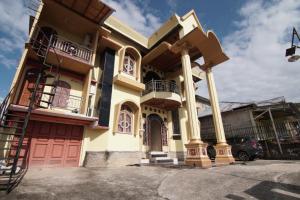 une grande maison avec colonnes et garage dans l'établissement OYO 92818 Penginapan Garuda Syariah, 