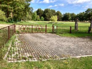 a gate in a field with a fence at Irbītes in Mērsrags