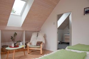 a bedroom with a vaulted ceiling with a skylight at Escape to PaulssonPaleo in Simlångsdalen