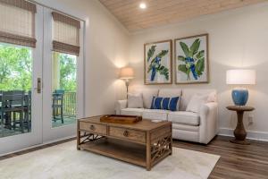 a living room with a couch and a table at Island Soul Rendezvous Bay Villa - Unit 4 - 500 Lemoyne condo in Dauphin Island