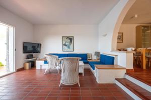 a living room with a blue couch and chairs at Holiday Home Zaton in Dubrovnik