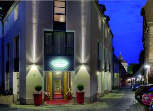 a building with a sign on the side of a street at Dürer-Hotel in Nuremberg