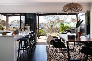 a kitchen and dining room with tables and chairs at Fontaine in Daylesford
