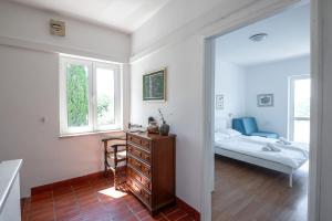 a bedroom with a dresser and a bed in a room at Holiday Home Zaton in Dubrovnik