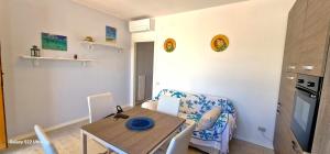 a small dining room with a table and a chair at Brezza di Mare - Casa Casoni in Marcelli