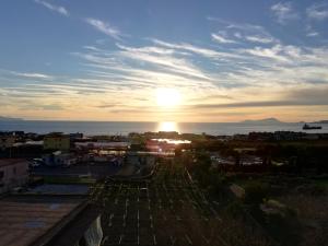 a view of the sunset from the roof of a building at B&B MaryGe in Ercolano