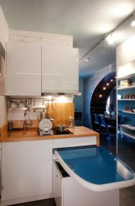 a kitchen with white cabinets and a blue sink at high end suite at the center of Heraklion in Heraklio