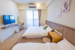 Een bed of bedden in een kamer bij 悠日 Lazy Days 澎湖民宿