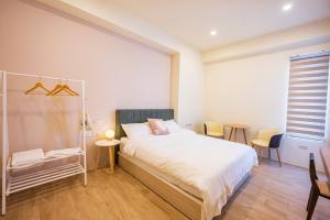 Een bed of bedden in een kamer bij 悠日 Lazy Days 澎湖民宿