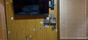 a flat screen tv on a wall with stickers on it at Apartment in a guest house in Almaty