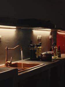 a kitchen counter with a sink and a sink at Cave Beach House Milos in Provatas