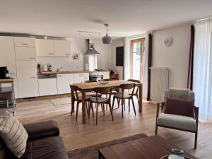 a kitchen and dining room with a table and chairs at apartment Alpenrose in Saas-Grund