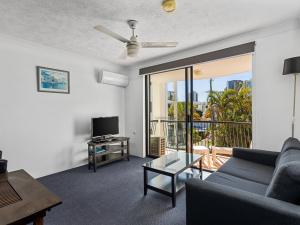 a living room with a couch and a table at Chevron Palms in Gold Coast