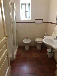 a bathroom with a toilet and a sink at Antica dimora Palazzo Rossi in Marsico Vetere