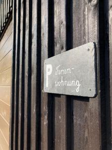 a sign on the side of a wooden fence at MariaDora in Alter Graben