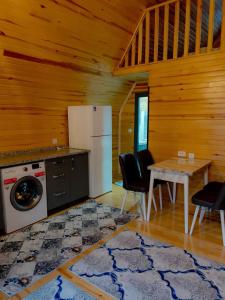 a kitchen with a refrigerator and a table with chairs at Riviera bungalow evleri demre 2 in Demre