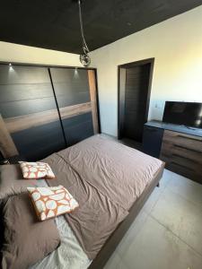 a bedroom with a bed with two pillows on it at Luxury Penthouse in Tal-Pietà