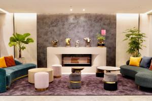 a living room with two couches and a fireplace at Tenz Go Hotel in Kaohsiung