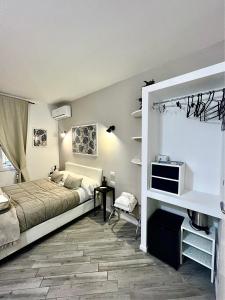 a bedroom with a bed and a tv on a wall at Spagna Rooms in Rome