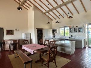 a kitchen and dining room with a table and chairs at Naivasha 4-Bedroom All Ensuite Cottage in Naivasha