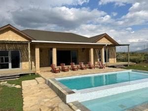 a house with a swimming pool in front of a house at Naivasha 4-Bedroom All Ensuite Cottage in Naivasha
